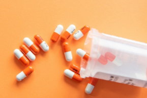 orange and white medication pill